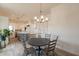 Open dining area with a round table, seating for four, and a view into the kitchen at 8502 E Santa Catalina Dr, Scottsdale, AZ 85255