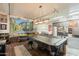 Expansive game room features pool table, overhead lighting, and storage at 8502 E Santa Catalina Dr, Scottsdale, AZ 85255