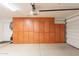 Garage features built-in brown cabinets, offering plenty of space for storage, keeping the area tidy and organized at 8502 E Santa Catalina Dr, Scottsdale, AZ 85255