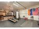 Versatile garage space features gym equipment, a pool table, and ample room for storage or hobbies at 8502 E Santa Catalina Dr, Scottsdale, AZ 85255