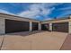 Spacious four-car garage offers ample parking and storage space with an additional basketball hoop and driveway area at 8502 E Santa Catalina Dr, Scottsdale, AZ 85255