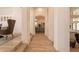 Arched hallway with wood look tile flooring, natural light and views of the kitchen at 8502 E Santa Catalina Dr, Scottsdale, AZ 85255