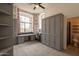 Versatile home office with built-in storage, murphy bed, and stylish gray finish at 8502 E Santa Catalina Dr, Scottsdale, AZ 85255