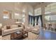 Bright and airy living room with high ceilings, hardwood floors, and neutral-toned furniture at 8502 E Santa Catalina Dr, Scottsdale, AZ 85255