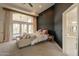 Bright main bedroom features a private patio, ceiling fan, and dark accent wall at 8502 E Santa Catalina Dr, Scottsdale, AZ 85255