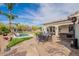 Inviting outdoor living area boasts a pool, gazebo, seating, and kitchen, perfect for entertaining and relaxation at 8502 E Santa Catalina Dr, Scottsdale, AZ 85255