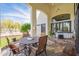 Charming covered patio with dining table, chairs, and a view of the spacious backyard and playset at 8502 E Santa Catalina Dr, Scottsdale, AZ 85255