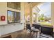 Relaxing outdoor patio featuring comfortable seating, a firebox, and views of the landscaped backyard and pool at 8502 E Santa Catalina Dr, Scottsdale, AZ 85255