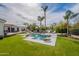 Backyard featuring a sparkling pool, lush landscaping, and comfortable lounge area for relaxation at 8502 E Santa Catalina Dr, Scottsdale, AZ 85255