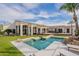 Spacious backyard featuring a pool, lush landscaping, and an outdoor kitchen, great for entertaining at 8502 E Santa Catalina Dr, Scottsdale, AZ 85255