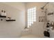 White marble shower with a glass block window and rain shower head at 8502 E Santa Catalina Dr, Scottsdale, AZ 85255