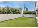 Green synthetic lawn in backyard with lush landscaping and desert vegetation at 902 W Glendale Ave # 102, Phoenix, AZ 85021