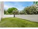 Backyard featuring lush artificial lawn, vegetation, and gated access at 902 W Glendale Ave # 102, Phoenix, AZ 85021