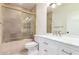 Bathroom with white cabinets, marble countertop, and shower over tub with glass enclosure at 902 W Glendale Ave # 102, Phoenix, AZ 85021
