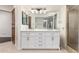 This bathroom features double vanity sinks, tile flooring, and a glass shower at 902 W Glendale Ave # 102, Phoenix, AZ 85021