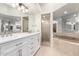 Large bathroom features double vanity, soaking tub, and glass shower at 902 W Glendale Ave # 102, Phoenix, AZ 85021