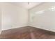 Spacious bedroom with dark wood floors and unique glass block window at 902 W Glendale Ave # 102, Phoenix, AZ 85021