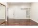 Bedroom with hardwood floors, a door and glass-block window that provides natural light at 902 W Glendale Ave # 102, Phoenix, AZ 85021
