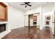 Bright bedroom featuring hardwood floors, closet with mirrored doors, and a cozy fireplace at 902 W Glendale Ave # 102, Phoenix, AZ 85021