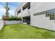 Building exterior with patio access to artificial lawn, lush vegetation, and desert flora at 902 W Glendale Ave # 102, Phoenix, AZ 85021