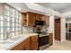 Kitchen boasts stone countertops, stainless steel appliances, and wooden cabinetry at 902 W Glendale Ave # 102, Phoenix, AZ 85021
