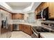 This kitchen is equipped with stainless steel appliances, stone countertops, and tile backsplash at 902 W Glendale Ave # 102, Phoenix, AZ 85021