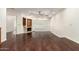 Spacious living room featuring hardwood floors, fireplace, and a sliding glass door with white shutters at 902 W Glendale Ave # 102, Phoenix, AZ 85021