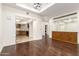 Open living room area with hardwood floors, a coffered ceiling, and a built-in cabinet at 902 W Glendale Ave # 102, Phoenix, AZ 85021
