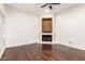 A living room with hardwood floors, a ceiling fan, and a fireplace at 902 W Glendale Ave # 102, Phoenix, AZ 85021