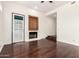 Living room showcasing dark wood floors, fireplace, and outdoor access at 902 W Glendale Ave # 102, Phoenix, AZ 85021