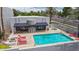 Beautiful in-ground pool with red lounge chairs and a jacuzzi in a fenced backyard at 902 W Glendale Ave # 102, Phoenix, AZ 85021