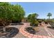 Secluded backyard with mature trees, gravel areas, and brick pavers at 922 S 80Th St, Mesa, AZ 85208
