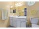 Compact bathroom features a white vanity, a well-lit mirror, and a toilet at 922 S 80Th St, Mesa, AZ 85208