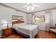 Comfortable bedroom with hardwood floors, a ceiling fan, and large window overlooking the backyard at 922 S 80Th St, Mesa, AZ 85208