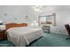 Light-filled bedroom with ceiling fan, window view, and carpeted floor at 922 S 80Th St, Mesa, AZ 85208