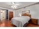 Bright bedroom featuring hardwood floors, ceiling fan, ample closet space, and side table lighting at 922 S 80Th St, Mesa, AZ 85208