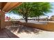 Covered front porch with seating area offers a relaxing outdoor space overlooking the street at 922 S 80Th St, Mesa, AZ 85208