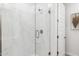 Modern walk-in shower featuring elegant marble-style tiling and a glass door at 9819 S 11Th St, Phoenix, AZ 85042