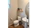 Powder room featuring white fixtures, hardwood floors, and decor at 984 W Belmont Red Trl, San Tan Valley, AZ 85143