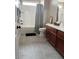 Well-lit bathroom with modern vanity, tiled floors, and shower-tub combination at 984 W Belmont Red Trl, San Tan Valley, AZ 85143