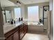 Bright primary bath featuring double vanity, soaking tub, and glass shower at 984 W Belmont Red Trl, San Tan Valley, AZ 85143