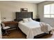 Cozy bedroom with a gray headboard, desk, and ample natural light at 984 W Belmont Red Trl, San Tan Valley, AZ 85143