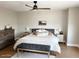 Cozy bedroom with soft lighting, wood floors, plush bedding, and decorative bench at 984 W Belmont Red Trl, San Tan Valley, AZ 85143