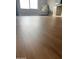 Bright bedroom with wood floors, a cozy chair, and natural light from a large window at 984 W Belmont Red Trl, San Tan Valley, AZ 85143