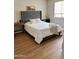 This bedroom has stylish decor, warm wood floors, and soft textures at 984 W Belmont Red Trl, San Tan Valley, AZ 85143