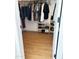 Walk-in closet featuring hardwood floors and lots of hanging space at 984 W Belmont Red Trl, San Tan Valley, AZ 85143