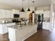 Bright kitchen with granite countertops, an island with a sink, stainless steel appliances, and a pantry at 984 W Belmont Red Trl, San Tan Valley, AZ 85143