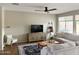 Inviting living room boasts a ceiling fan, large windows, and lots of comfortable seating at 984 W Belmont Red Trl, San Tan Valley, AZ 85143
