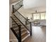 View of the living room showing the staircase, high ceilings, and large windows at 984 W Belmont Red Trl, San Tan Valley, AZ 85143