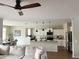 Open concept living room flows to a well-equipped kitchen and dining area, complete with a ceiling fan at 984 W Belmont Red Trl, San Tan Valley, AZ 85143